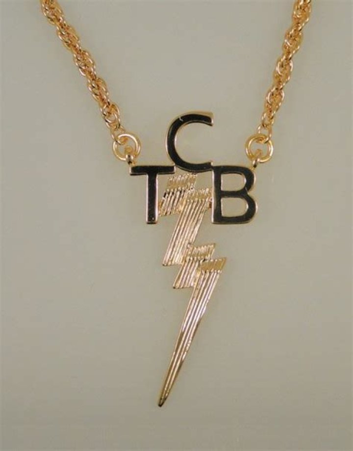 A King's Adornment: Elvis In His Iconic TCB Necklace